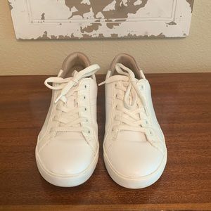 Naturalizer white leather sneaker with taupe suede heel accent.